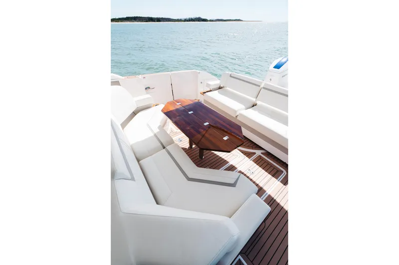 Slide: The Image of Luxurious 2023 Tiara 48 yacht deck with elegant seating and wooden table, overlooking serene waters. - 40