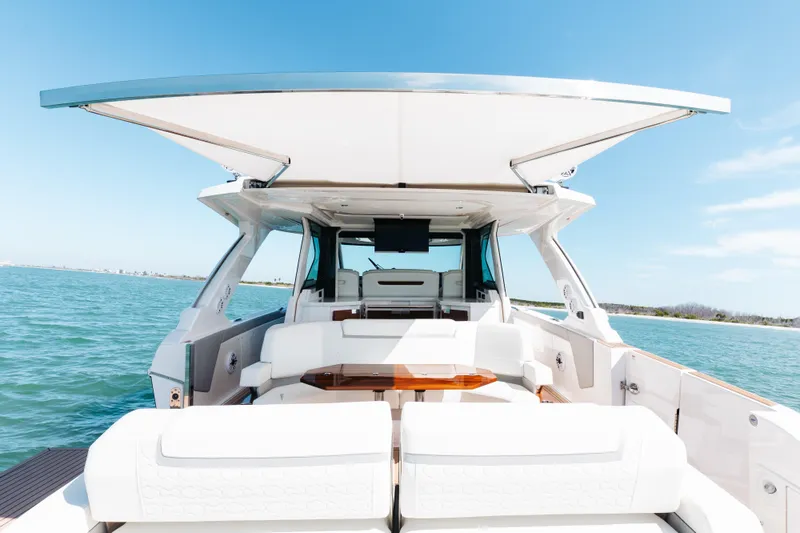 Slide: The Image of Luxurious 2023 Tiara 48 yacht with spacious deck and modern design on open water. - 48