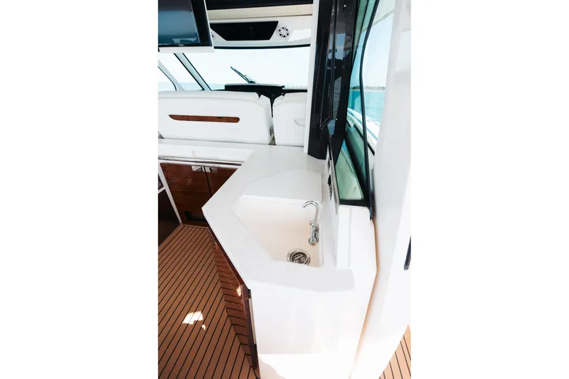Slide: The Image of 2023 Tiara 48 yacht interior with sleek sink and modern design. - 49