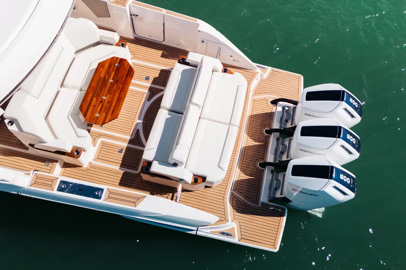 Slide: The Image of Aerial view of 2023 Tiara 48 yacht deck with triple Mercury engines. - 5