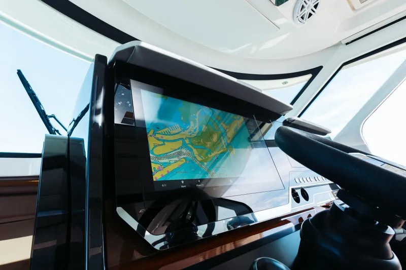 Slide: The Image of Dashboard of 2023 Tiara 48 yacht with navigation screen and steering wheel. - 51