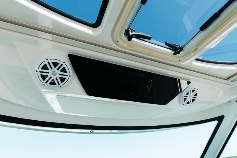 Slide: The Image of 2023 Tiara 48 boat interior with speakers and sunroof. - 53