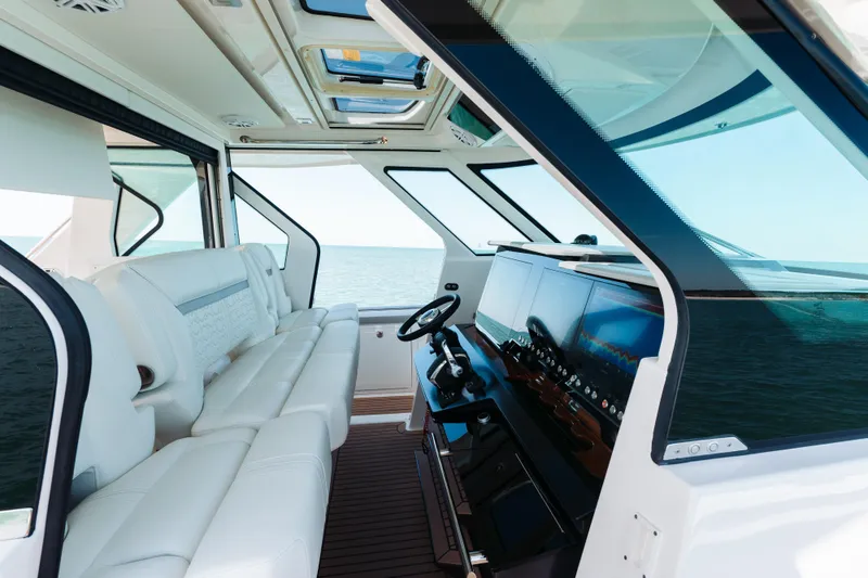 Slide: The Image of Luxurious interior of 2023 Tiara 48 yacht with modern helm and panoramic ocean view. - 54