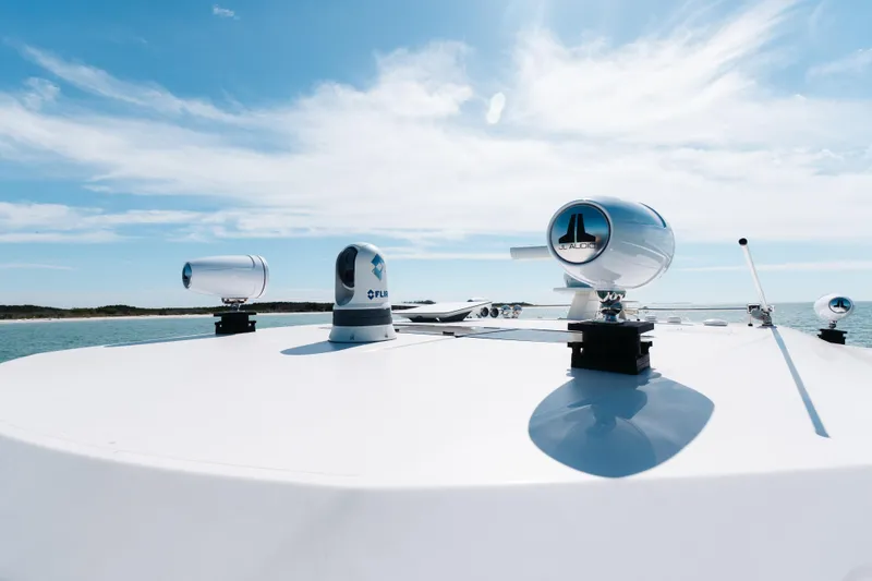 Slide: The Image of 2023 Tiara 48 yacht with advanced audio and navigation systems under a clear sky. - 55