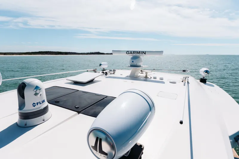 Slide: The Image of 2023 Tiara 48 yacht with Garmin and FLIR equipment on deck, cruising on open water. - 56