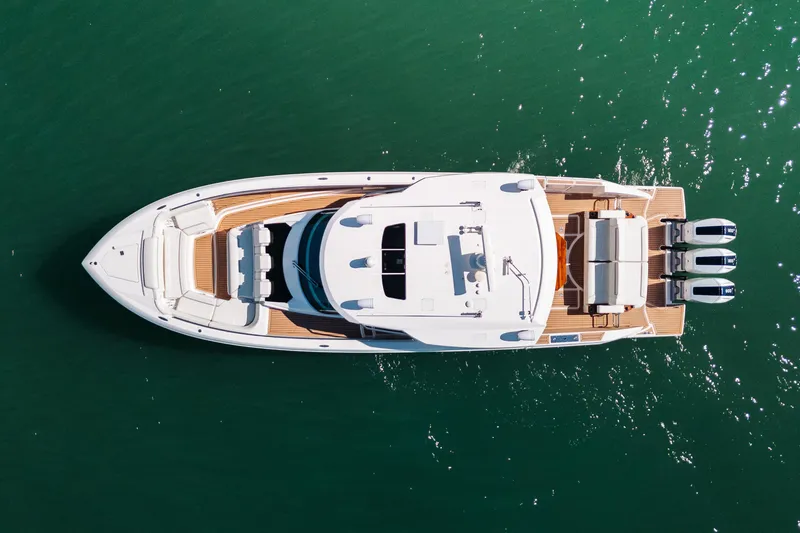 Slide: The Image of Aerial view of 2023 Tiara 48 yacht on green water. - 6