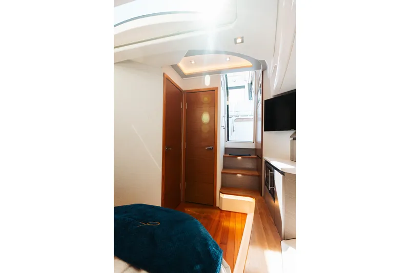 Slide: The Image of Interior of 2023 Tiara 48 yacht, featuring wooden stairs and modern design elements. - 62
