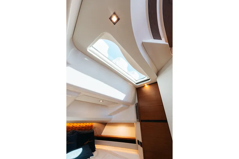 Slide: The Image of Interior of 2023 Tiara 48 yacht, featuring a skylight and modern design elements. - 63