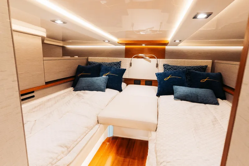 Slide: The Image of Luxurious cabin interior of 2023 Tiara 48 yacht with elegant bedding and ambient lighting. - 64