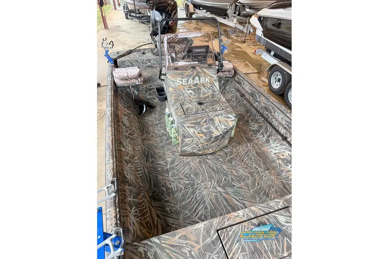 Slide: The Image of 2022 SeaArk 180 RXT boat with camouflage interior and fishing rod holders. - 11