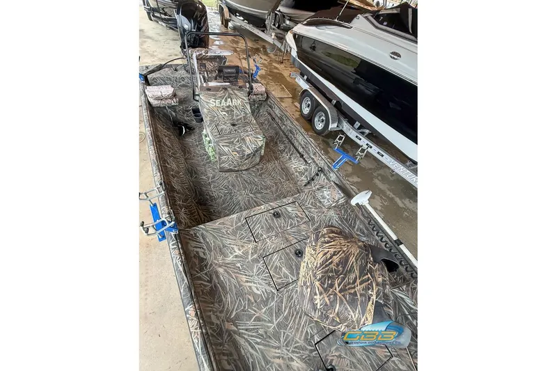 Slide: The Image of 2022 SeaArk 180 RXT boat with camouflage design and fishing rod holders. - 12
