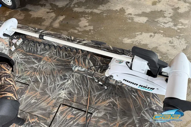 Slide: The Image of 2022 SeaArk 180 RXT boat with camouflage design on a trailer. - 19