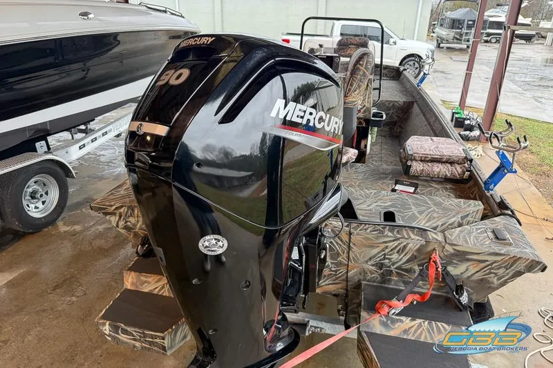 Slide: The Image of 2022 SeaArk 180 RXT boat interior with camouflage design and storage compartment. - 20