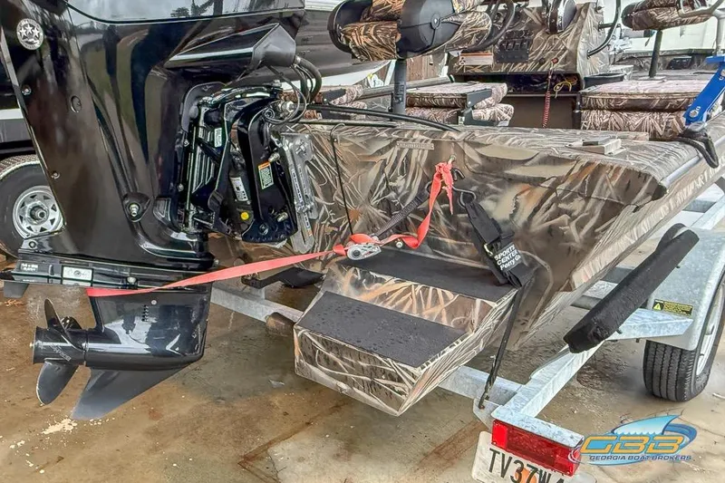 Slide: The Image of 2022 SeaArk 180 RXT boat interior with camouflage design and mounted accessories. - 22