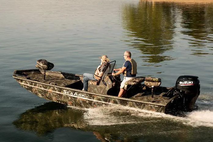 Slide: The Image of 2022 SeaArk 180 RXT boat with camo design and outboard motor in garage. - 27