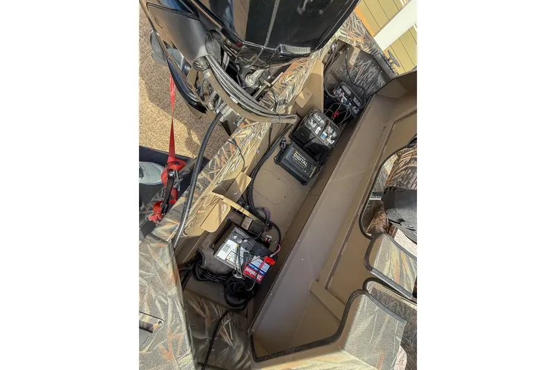 Slide: The Image of Interior view of 2022 SeaArk 180 RXT boat showing engine and battery setup. - 35
