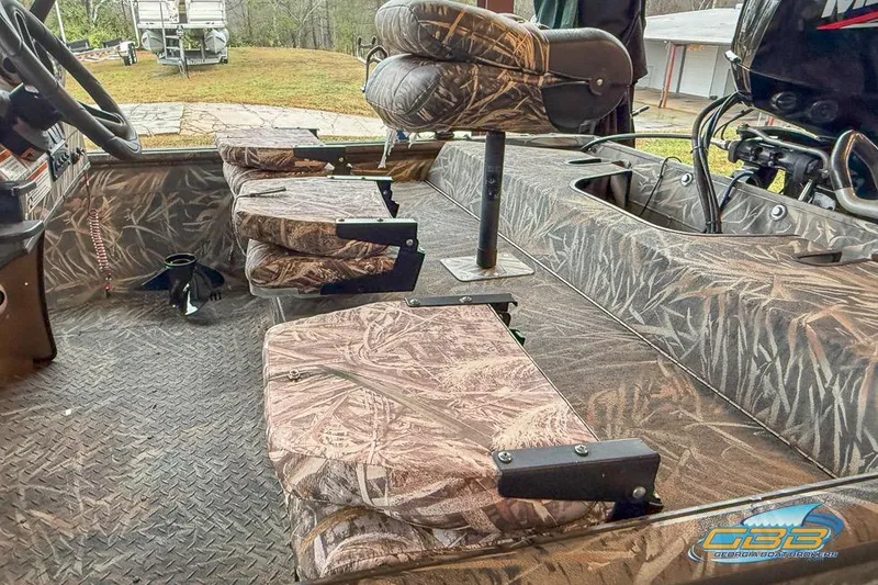 Slide: The Image of 2022 SeaArk 180 RXT boat interior with camouflage design and modern controls. - 9