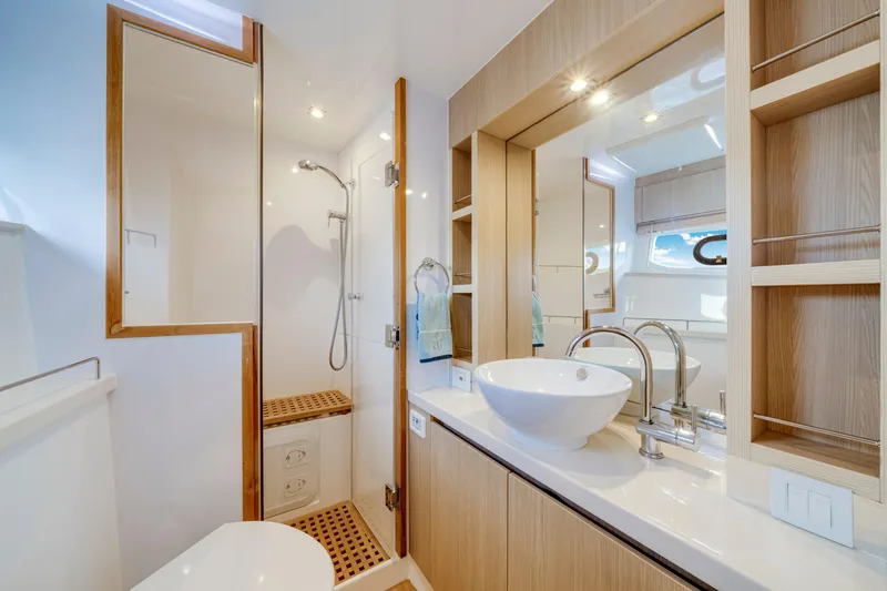 Slide: The Image of Luxurious bathroom interior of 2019 Aquila 44 Yacht with modern fixtures and wooden accents. - 20