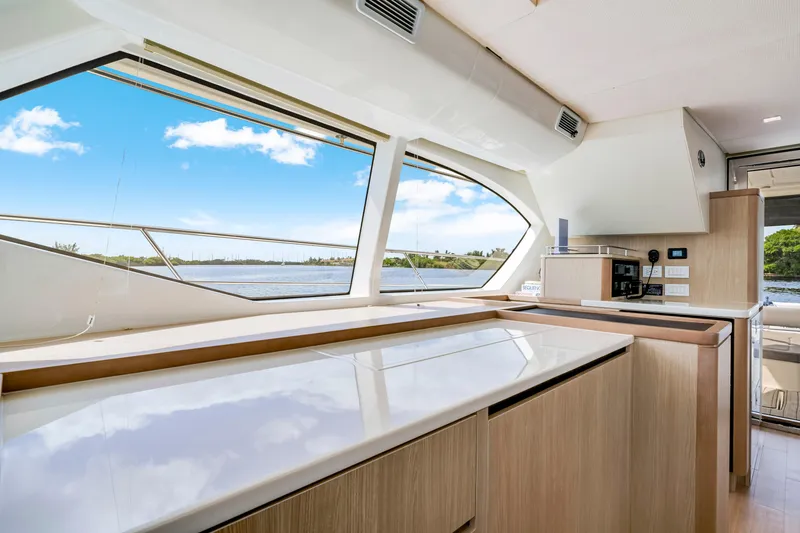 Slide: The Image of Interior view of 2019 Aquila 44 Yacht kitchen with large windows and modern design. - 22