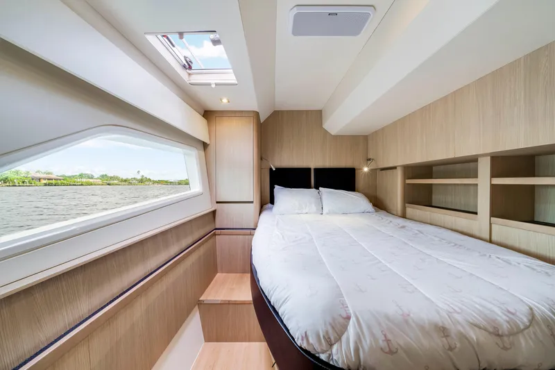 Slide: The Image of Luxurious bedroom interior of 2019 Aquila 44 Yacht with scenic water view. - 24