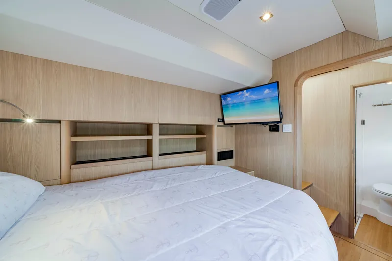 Slide: The Image of Luxurious bedroom interior of 2019 Aquila 44 Yacht with TV and ensuite bathroom. - 25