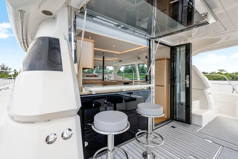 Slide: The Image of 2019 Aquila 44 Yacht interior with modern seating and open deck view. - 35