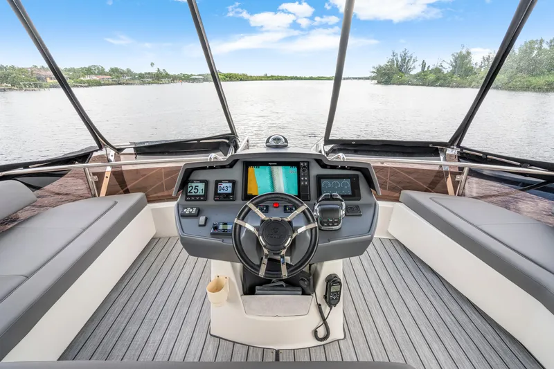 Slide: The Image of 2019 Aquila 44 Yacht helm with modern navigation system and panoramic water view. - 51