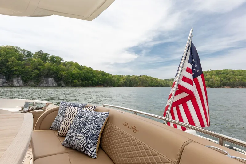 Slide: The Image of 2018 Sea Ray L650 Fly yacht with American flag on lake. - 15