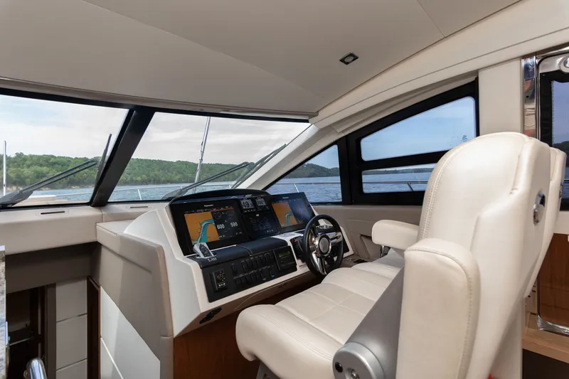 Slide: The Image of Interior view of 2018 Sea Ray L650 Fly cockpit with controls. - 28
