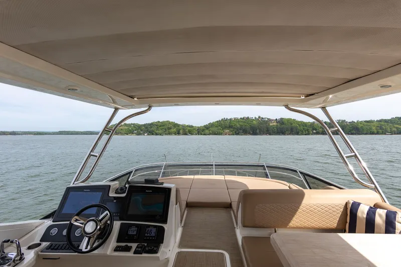 Slide: The Image of Interior view of 2018 Sea Ray L650 Fly yacht overlooking the water. - 38
