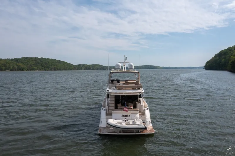Slide: The Image of Sea Ray L650 Fly 2018 on a calm lake with wooded shores. - 6