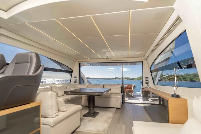 Slide: The Image of Luxurious interior of a 2018 Pershing 70 yacht with panoramic windows and elegant seating. - 10