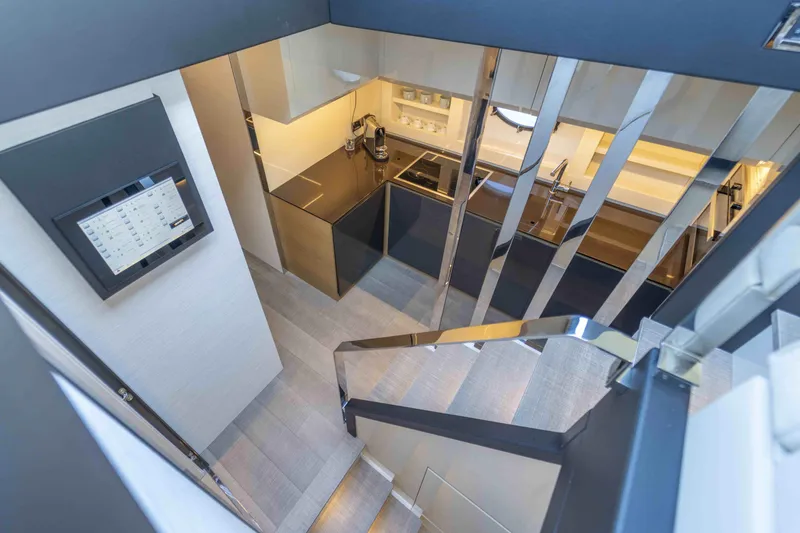 Slide: The Image of Modern interior of 2018 Pershing 70 yacht with sleek kitchen and staircase. - 19