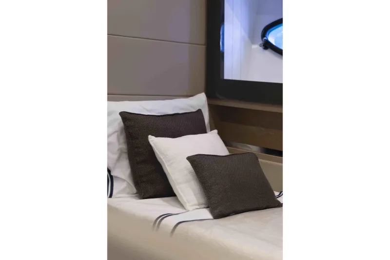 Slide: The Image of Luxurious interior of 2018 Pershing 70 yacht with elegant cushions and window view. - 22