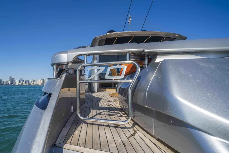 Slide: The Image of 2018 Pershing 70 yacht on water with city skyline in background. - 25