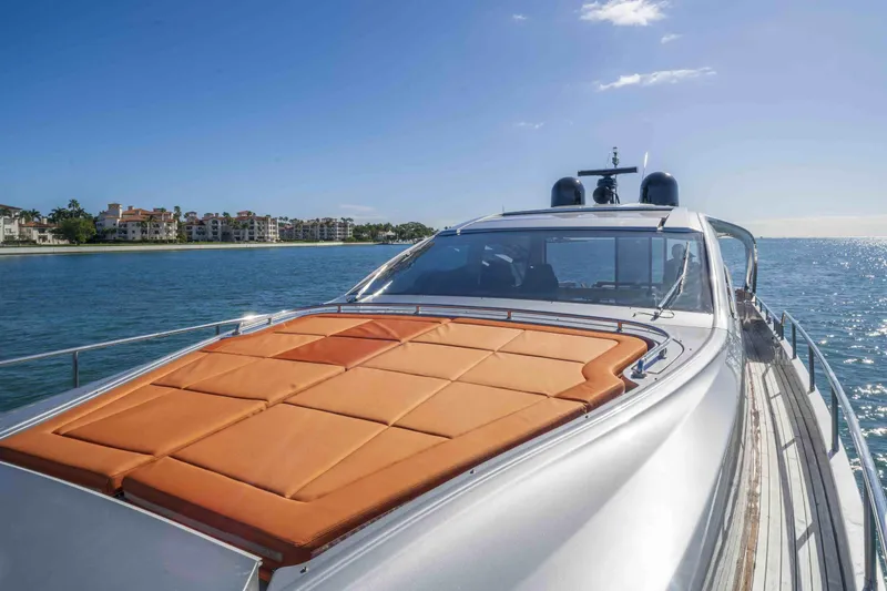 Slide: The Image of 2018 Pershing 70 yacht cruising on a sunny day near coastal residences. - 26