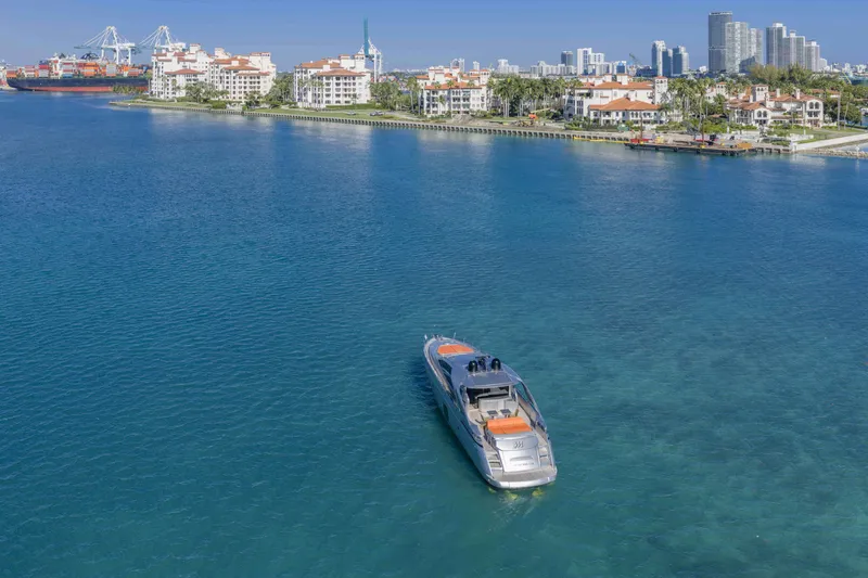 Slide: The Image of 2018 Pershing 70 yacht cruising near coastal city skyline. - 27