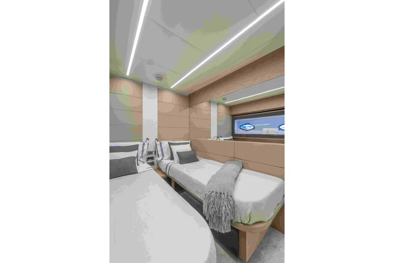 Slide: The Image of Luxurious interior of 2018 Pershing 70 yacht with modern twin beds and sleek design. - 6