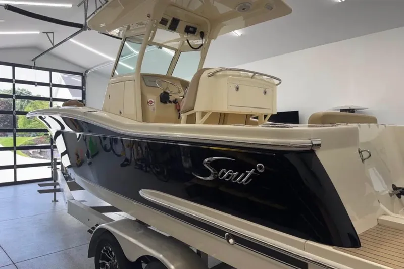 Slide: The Image of 2016 Scout 255 LXF boat in a garage, showcasing sleek design and modern features. - 13