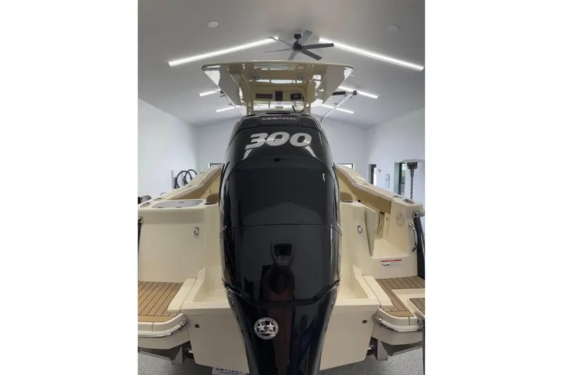 Slide: The Image of 2016 Scout 255 LXF boat with powerful 300 horsepower engine in a modern garage. - 14