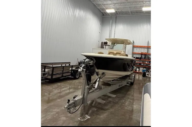 Slide: The Image of 2016 Scout 255 LXF boat on trailer in indoor storage facility. - 18
