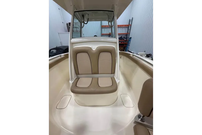 Slide: The Image of 2016 Scout 255 LXF boat interior with tan seating and sleek design. - 21
