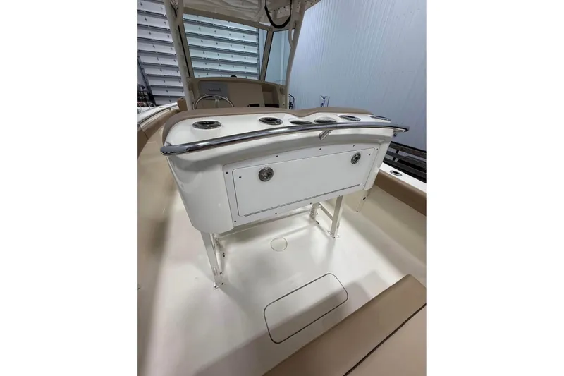 Slide: The Image of 2016 Scout 255 LXF boat interior with console and seating area. - 22