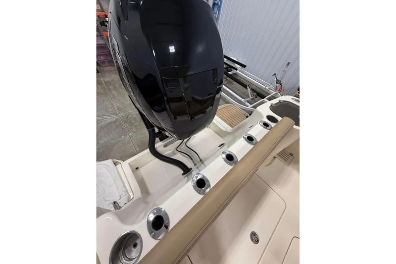 Slide: The Image of 2016 Scout 255 LXF boat with powerful outboard motor and rod holders. - 23