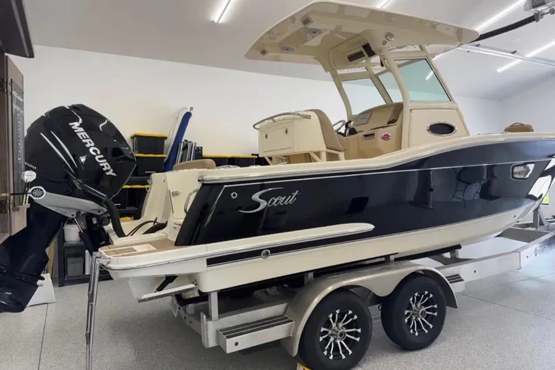 The Image of 2016 Scout 255 LXF boat with Mercury engine on trailer in garage. - 8