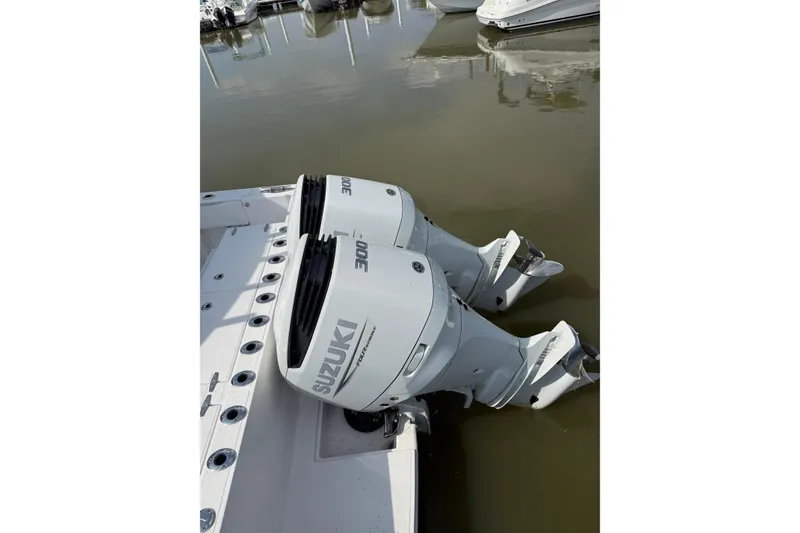 Slide: The Image of 2023 Stamas 31T Aventura with dual Suzuki 300 outboard engines docked. - 17