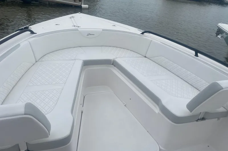 Slide: The Image of 2023 Stamas 31T Aventura boat interior with white cushioned seating. - 23