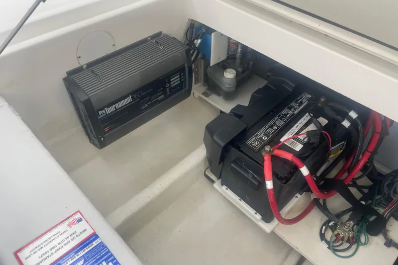 Slide: The Image of 2023 Stamas 31T Aventura boat battery compartment with ProTournament 360 charger. - 30
