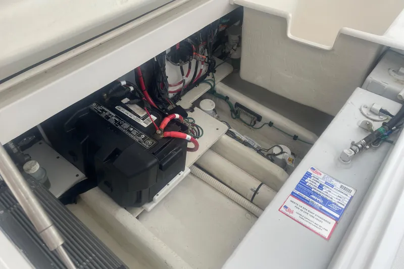 Slide: The Image of 2023 Stamas 31T Aventura boat battery compartment with wiring and components. - 31