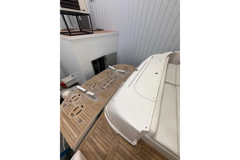 Slide: The Image of 2001 Sea Ray 560 Sedan Bridge yacht with teak deck in storage facility. - 13